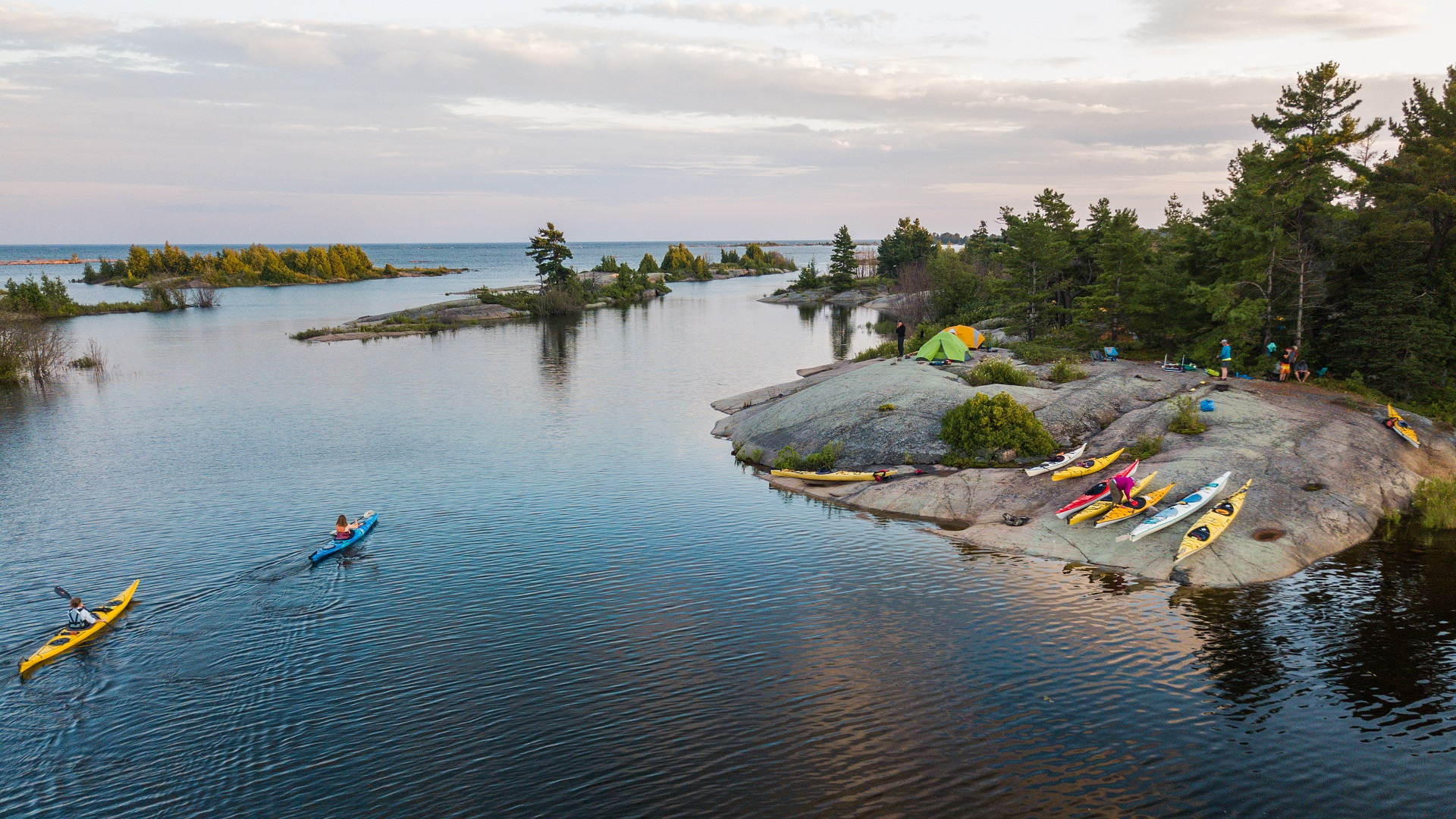 An aerial view of kayakers camping and paddling on the Great Lakes in northern Canada