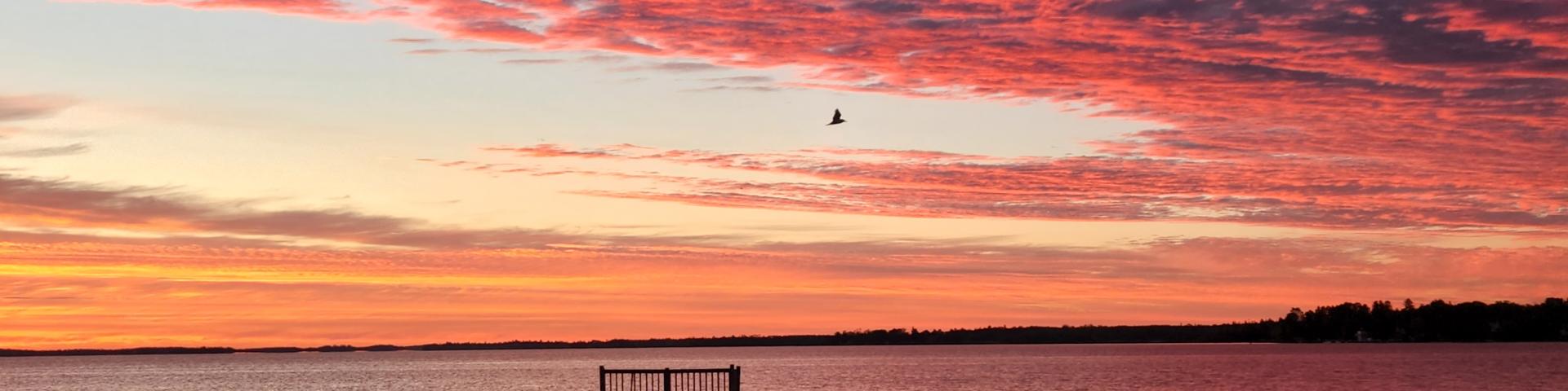A vibrant red sunset over Rainy Lake in Fort Frances, ONT, 2022