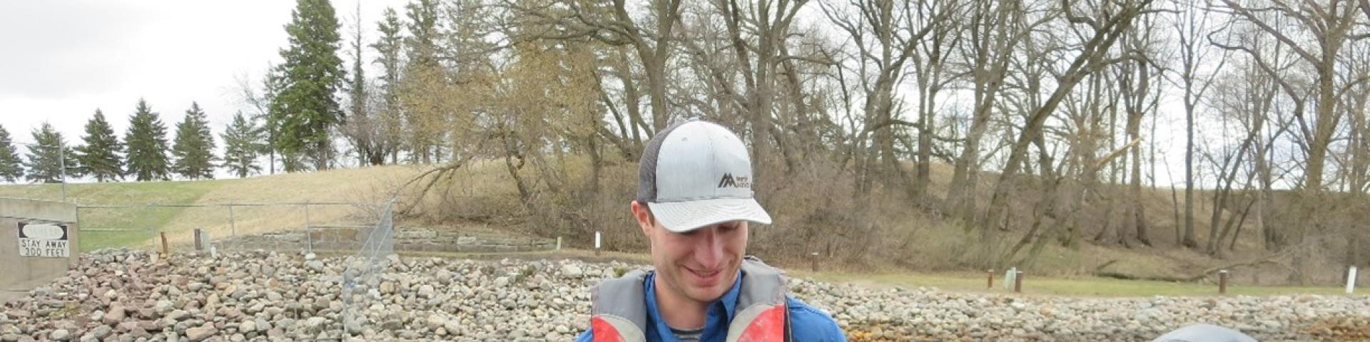 Researcher Marshall Stuart holds a lake sturgeon caught in the Red River watershed. Credit: Blake Logan